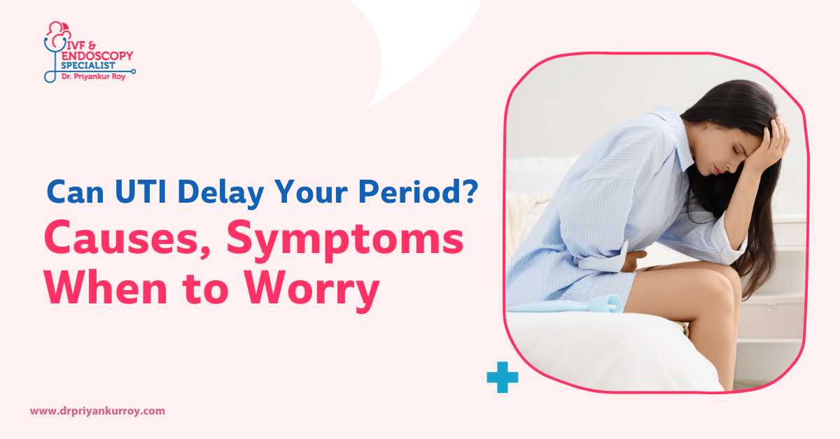 Woman sitting on bed holding her abdomen and head, showing discomfort related to UTI and delayed period, with text “Can UTI Delay Your Period? Causes, Symptoms, When to Worry